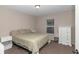 This cozy bedroom features neutral paint, a window, and a closet with storage shelves at 4111 Se 131St Ln, Belleview, FL 34420