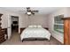 Cozy bedroom with a ceiling fan and natural light from the window at 4111 Se 131St Ln, Belleview, FL 34420