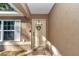 Inviting front entrance with a decorative wreath on the door and a welcoming 'HOME' door mat at 4111 Se 131St Ln, Belleview, FL 34420