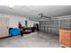 Spacious garage offers ample space for parking and storage with a gray garage door at 4111 Se 131St Ln, Belleview, FL 34420