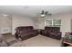 Cozy living room with comfortable seating, a ceiling fan, and natural light from a window at 4111 Se 131St Ln, Belleview, FL 34420