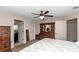Main bedroom with neutral carpet, ceiling fan, and ensuite bathroom at 4111 Se 131St Ln, Belleview, FL 34420