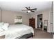 Cozy main bedroom with neutral carpet, ceiling fan, and ensuite bathroom at 4111 Se 131St Ln, Belleview, FL 34420
