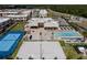 Aerial view of community amenities, including a pool, tennis court, and sand volleyball at 7540 Brooklyn Dr, Kissimmee, FL 34747