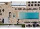 Aerial view of the community pool with lounge chairs, a hot tub, and a giant chess set in Magic Village Views at 7540 Brooklyn Dr, Kissimmee, FL 34747