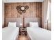 Cozy bedroom featuring two twin beds with stylish wood accent wall decor at 7540 Brooklyn Dr, Kissimmee, FL 34747