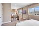 Bright bedroom with a cozy seating area, a large window, and neutral decor at 7540 Brooklyn Dr, Kissimmee, FL 34747