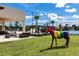 Beautiful clubhouse featuring an outdoor lounge area with a rainbow-colored horse statue at 7540 Brooklyn Dr, Kissimmee, FL 34747