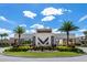 Community monument with a modern design surrounded by well-maintained landscaping and palm trees at 7540 Brooklyn Dr, Kissimmee, FL 34747