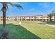 Beautiful condo community surrounded by lush lawn, landscaping, and palm trees at 7540 Brooklyn Dr, Kissimmee, FL 34747