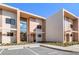Modern townhouse exterior with large windows and neutral color scheme against blue sky at 7540 Brooklyn Dr, Kissimmee, FL 34747