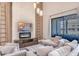 Elegant living room with modern fireplace, mounted TV, and comfortable seating at 7540 Brooklyn Dr, Kissimmee, FL 34747