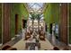 Spacious lobby with soaring skylight, verdant walls, and comfortable seating arrangement, providing an inviting atmosphere at 7540 Brooklyn Dr, Kissimmee, FL 34747