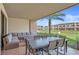 Relaxing patio with cushioned seating, dining table, and lush green lawn views at 7540 Brooklyn Dr, Kissimmee, FL 34747
