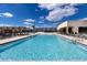 The zero entry pool has beach access and lounge chairs for a resort-style living at Magic Village Views at 7540 Brooklyn Dr, Kissimmee, FL 34747