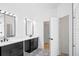 Modern bathroom boasts dual sinks, black cabinetry, mosaic tile flooring, and a glass shower at 113 Grand Reserve Ct, Davenport, FL 33837