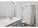Clean bathroom featuring gray vanity, white countertop, and tiled shower with curtain at 113 Grand Reserve Ct, Davenport, FL 33837
