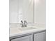 Modern bathroom sink with quartz countertop, gray cabinets, and large mirror at 113 Grand Reserve Ct, Davenport, FL 33837