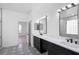 Modern bathroom boasts dual sinks, black cabinetry, mosaic tile flooring, and a glass shower at 113 Grand Reserve Ct, Davenport, FL 33837