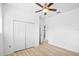 Clean bedroom with hardwood floors, closet, and neutral walls at 113 Grand Reserve Ct, Davenport, FL 33837