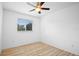 Inviting bedroom features hardwood floors, a ceiling fan, and a large window at 113 Grand Reserve Ct, Davenport, FL 33837