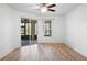 Spacious bedroom with wood floors, a ceiling fan, and sliding glass doors leading to the lanai at 113 Grand Reserve Ct, Davenport, FL 33837