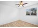 Bright bedroom featuring hardwood floors, a ceiling fan, and a window with blinds at 113 Grand Reserve Ct, Davenport, FL 33837