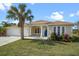 Charming single-story home featuring a lush front yard, well maintained landscaping and a welcoming blue front door at 113 Grand Reserve Ct, Davenport, FL 33837