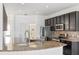 Modern kitchen with stainless steel appliances, granite countertops, and dark cabinetry at 113 Grand Reserve Ct, Davenport, FL 33837