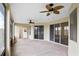 Spacious, screened lanai with ceiling fans and multiple sliding glass doors at 113 Grand Reserve Ct, Davenport, FL 33837