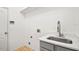 Modern laundry room with white quartz countertop, gray cabinets, and utility sink at 113 Grand Reserve Ct, Davenport, FL 33837