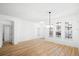 Inviting living space featuring wood floors, abundant natural light, and minimalist decor, perfect for relaxation and gatherings at 113 Grand Reserve Ct, Davenport, FL 33837