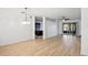 Spacious living room with wood floors, opening to a modern kitchen and sunroom for seamless entertaining at 113 Grand Reserve Ct, Davenport, FL 33837