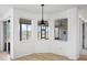 Bright living room featuring hardwood floors and ample natural light from large windows at 113 Grand Reserve Ct, Davenport, FL 33837