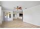 Open-concept living room with hardwood floors flowing into the kitchen and dining area at 113 Grand Reserve Ct, Davenport, FL 33837