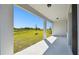 Outdoor back porch space showing a lush green landscape with a picturesque view and sturdy support beams at 1667 Ruby Ln, Lake Alfred, FL 33850
