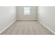 Neutral colored, empty bedroom with plush carpeting, neutral paint and trim, and a single window at 1667 Ruby Ln, Lake Alfred, FL 33850