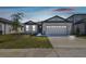 Charming single-Gathering home with a two-car garage, manicured lawn, and inviting curb appeal at 1667 Ruby Ln, Lake Alfred, FL 33850