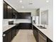 Open concept kitchen with stainless steel appliances, quartz countertops, and tile flooring at 1667 Ruby Ln, Lake Alfred, FL 33850