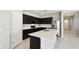 Modern kitchen with black cabinets, stainless appliances, tile floor and island with sink at 1667 Ruby Ln, Lake Alfred, FL 33850