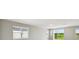 Spacious living room featuring multiple windows, an open floor plan, and light colored walls at 1667 Ruby Ln, Lake Alfred, FL 33850