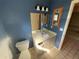 Cozy bathroom with blue walls, mirror, single sink, and tiled floor at 1880 N Crystal Lake Dr # 65, Lakeland, FL 33801