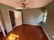 Bedroom with ceiling fan, hardwood floors, and a window providing natural light at 1880 N Crystal Lake Dr # 65, Lakeland, FL 33801