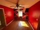 Bedroom with hardwood floors, ceiling fan, and geometric accent wall at 1880 N Crystal Lake Dr # 65, Lakeland, FL 33801