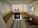 Functional kitchen with bright cabinets, stainless steel appliances, and breakfast bar at 1880 N Crystal Lake Dr # 65, Lakeland, FL 33801