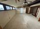 Spacious tiled room with multiple windows and a ceiling fan, flooded with natural light at 1880 N Crystal Lake Dr # 65, Lakeland, FL 33801