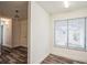 Bright living room featuring wood-look floors, a window with blinds, and a view into an adjacent space at 2639 Cayman Way, Winter Park, FL 32792