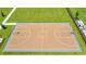 Aerial view of the community basketball court surrounded by lush green grass and manicured landscaping at 3217 Armstrong Ave, Clermont, FL 34714