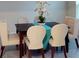 Elegant dining area featuring a dark wood table, cream chairs, and stylish decor accents at 3217 Armstrong Ave, Clermont, FL 34714