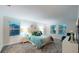 Spacious main bedroom featuring a large bed, stylish lamps, and ample natural light at 3217 Armstrong Ave, Clermont, FL 34714